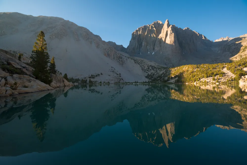 The under layer: real symmetry photograph of mountain and lake